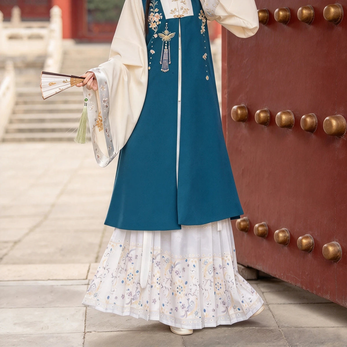 Peacock blue Hanfu outer vest paired with a standing-collar shirt and skirt