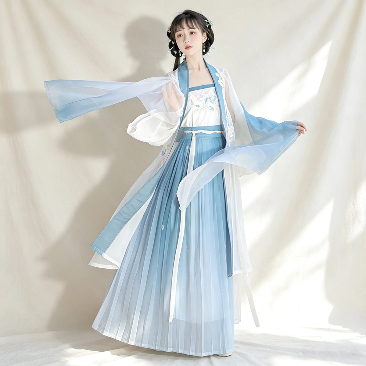 Women's blue wide-sleeve Beizi-style outer layer over a floral camisole