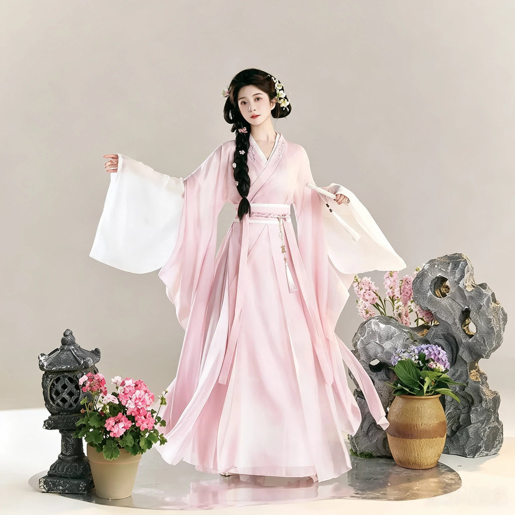 Women's soft pink Hanfu top with a long white skirt