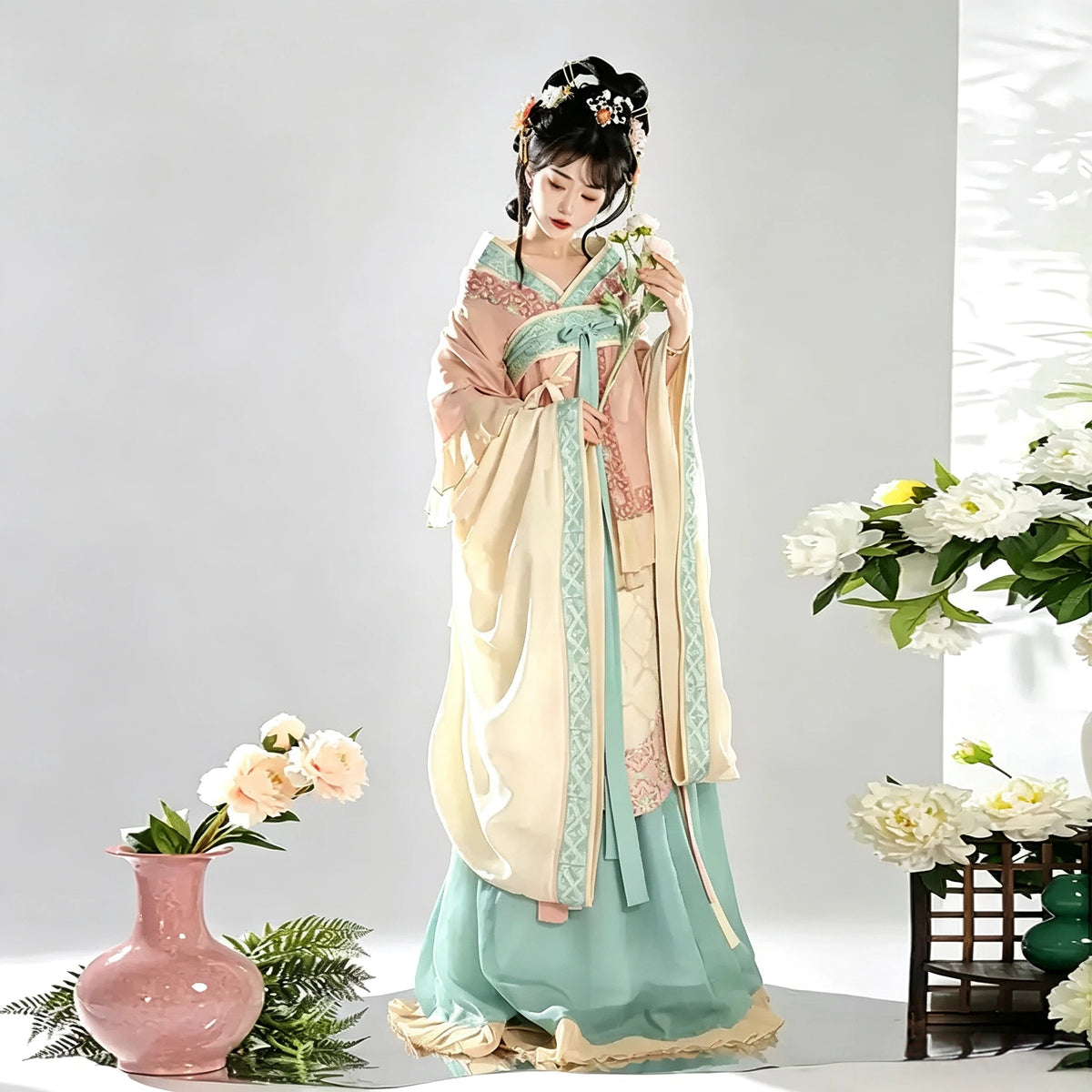 Women's pink and aqua Hanfu top paired with a layered skirt