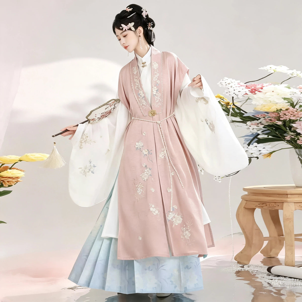 Ming-inspired Hanfu with a pink Bijia vest, white robe and blue pleated skirt