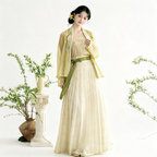 Soft yellow Hanfu gown with green accents and flowing fabric