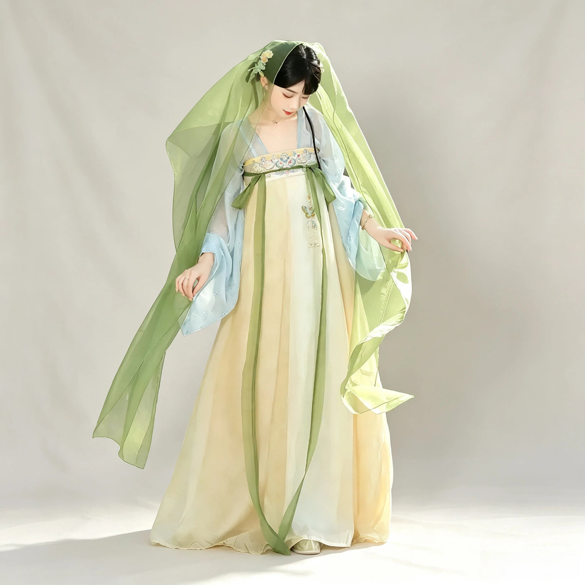 Pastel blue and yellow Tang-style Hanfu with floral embroidery and green shawl