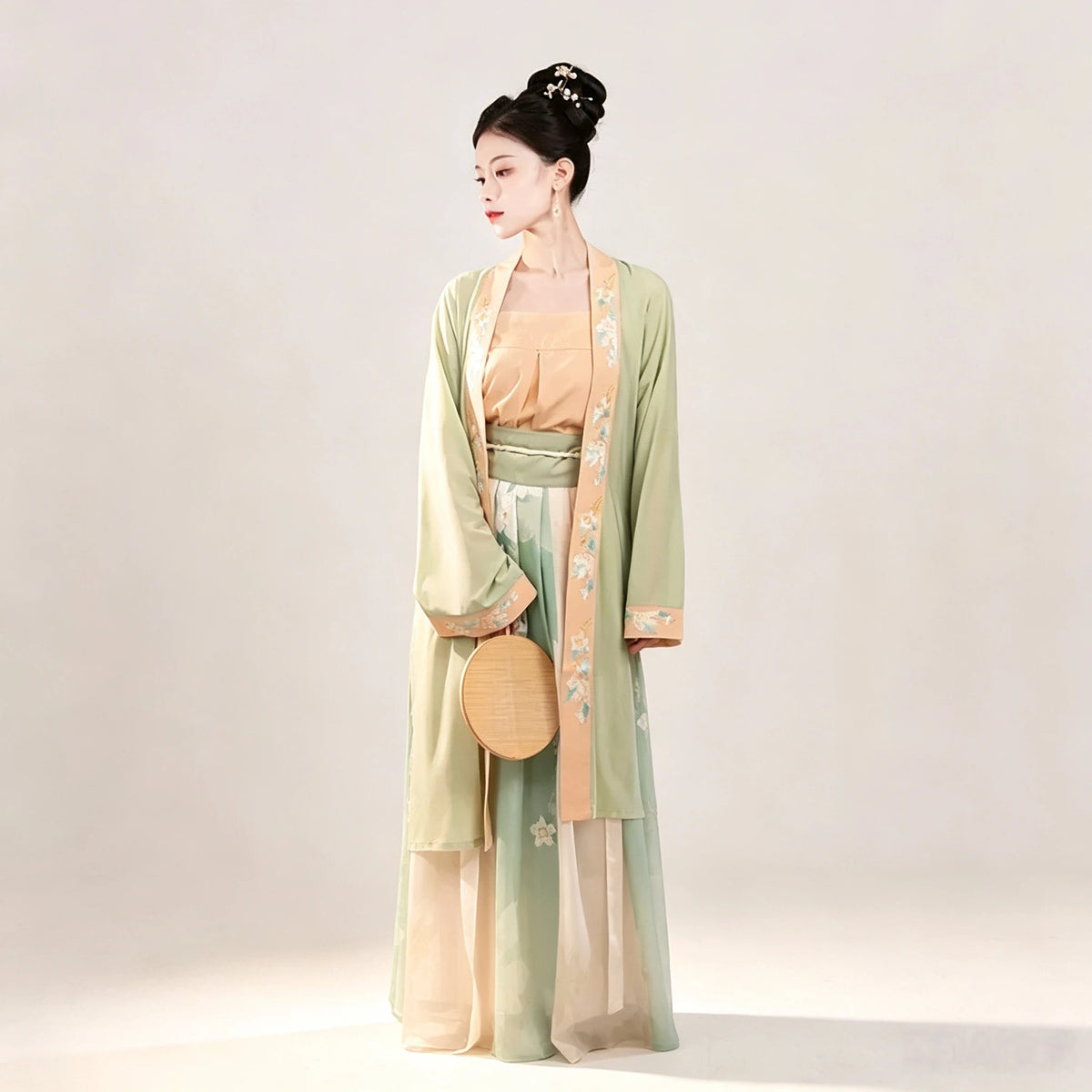 Song-style women's Hanfu with green outer cardigan and pleated skirt