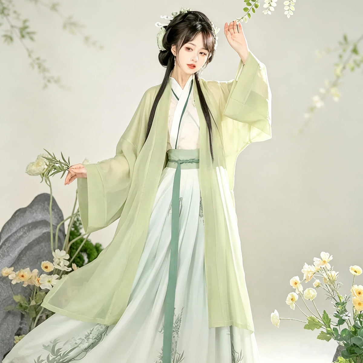 Women's green embroidered Hanfu top with a flowing white skirt