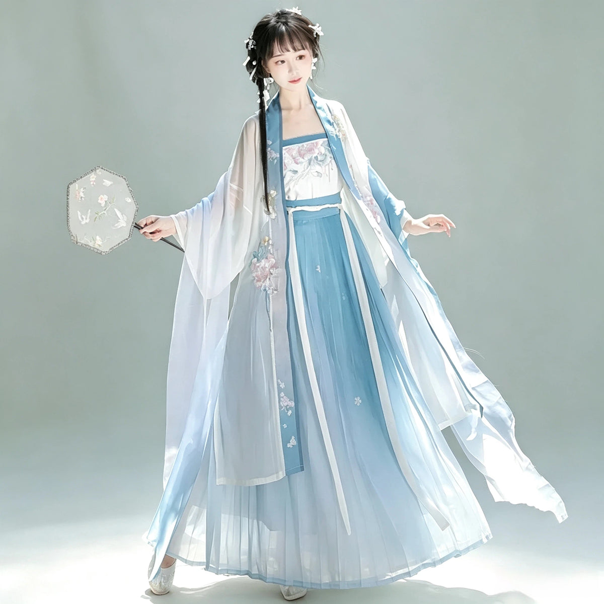 Women's blue Hanfu outer cardigan paired with a white skirt