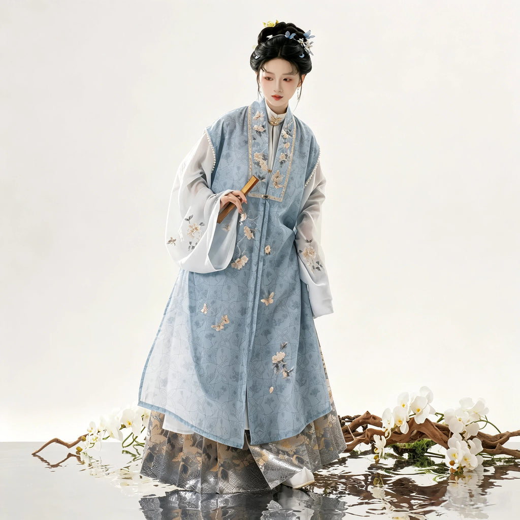 Women's blue Hanfu vest over a white robe and patterned skirt